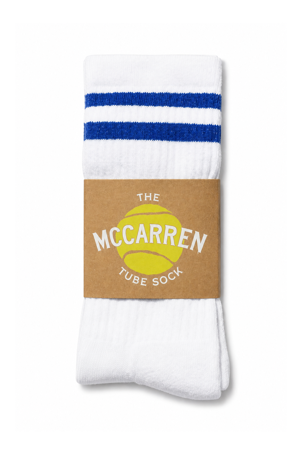 A pair of white tube socks with two blue stripes near the top, wrapped in a brown paper band that reads 'THE MCCARREN TUBE SOCK' with a yellow tennis ball graphic, on a white background.