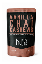 A stand-up pouch of Nat's Nuts Vanilla Chai Cashews on a plain white background. The packaging features a black center with large copper-pink and white text, and copper-pink bands at the top and bottom.