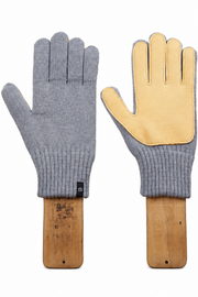 A pair of knit work gloves displayed side by side on wooden hangers against a plain white background. One glove shows the gray knit back, and the other shows the light tan leather palm side.