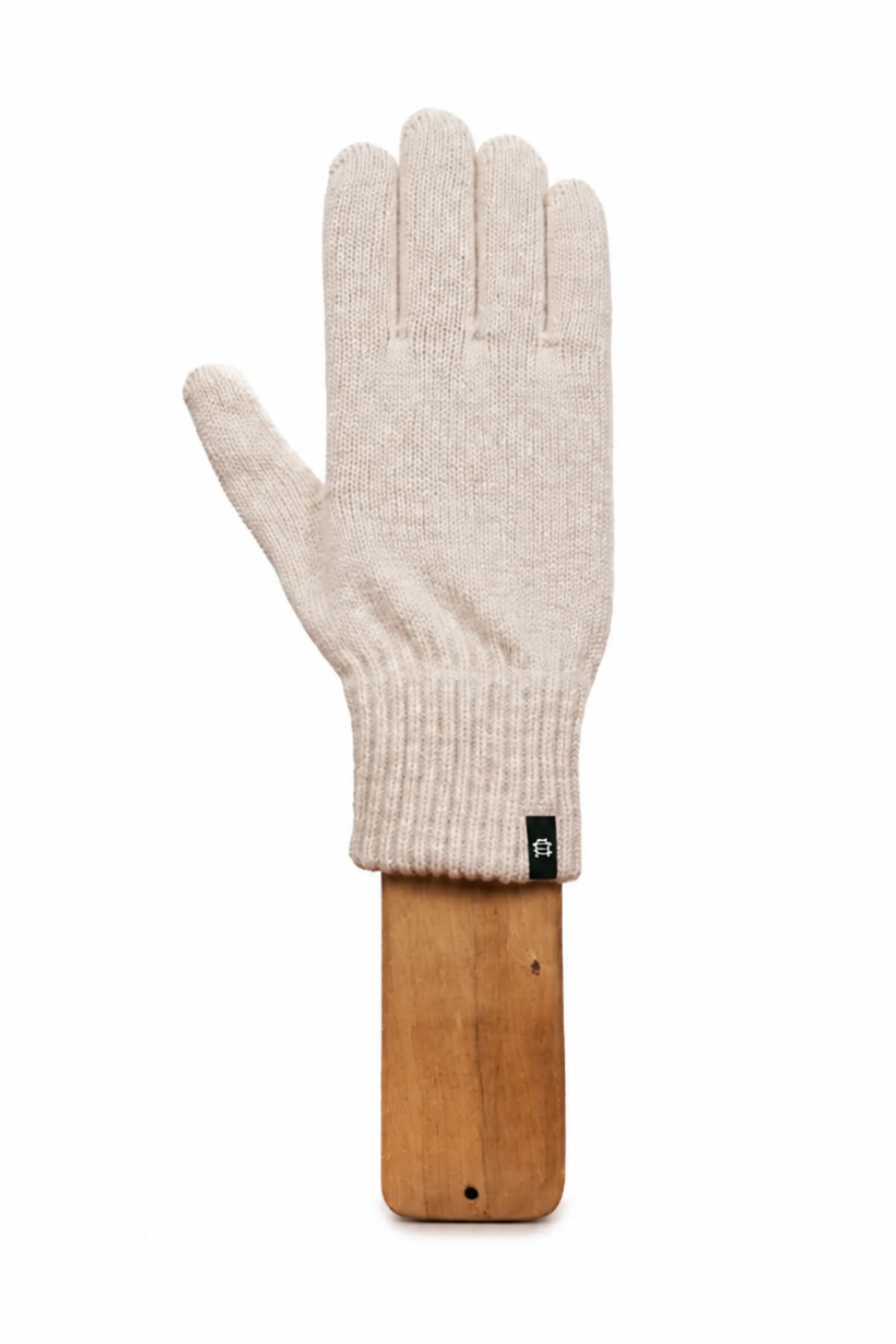 A single cream-colored knit glove displayed on a wooden stand against a solid white background.