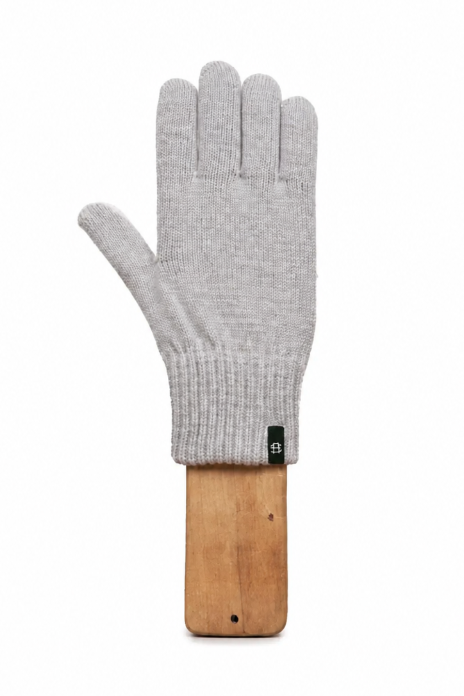 A light gray knit glove displayed on a wooden stand against a plain white background.