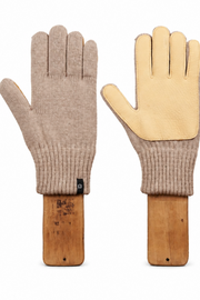 A pair of knit work gloves shown flat against a white background, mounted on wooden handles. One glove is beige with a tan leather palm, and the other is tan with a beige leather palm.