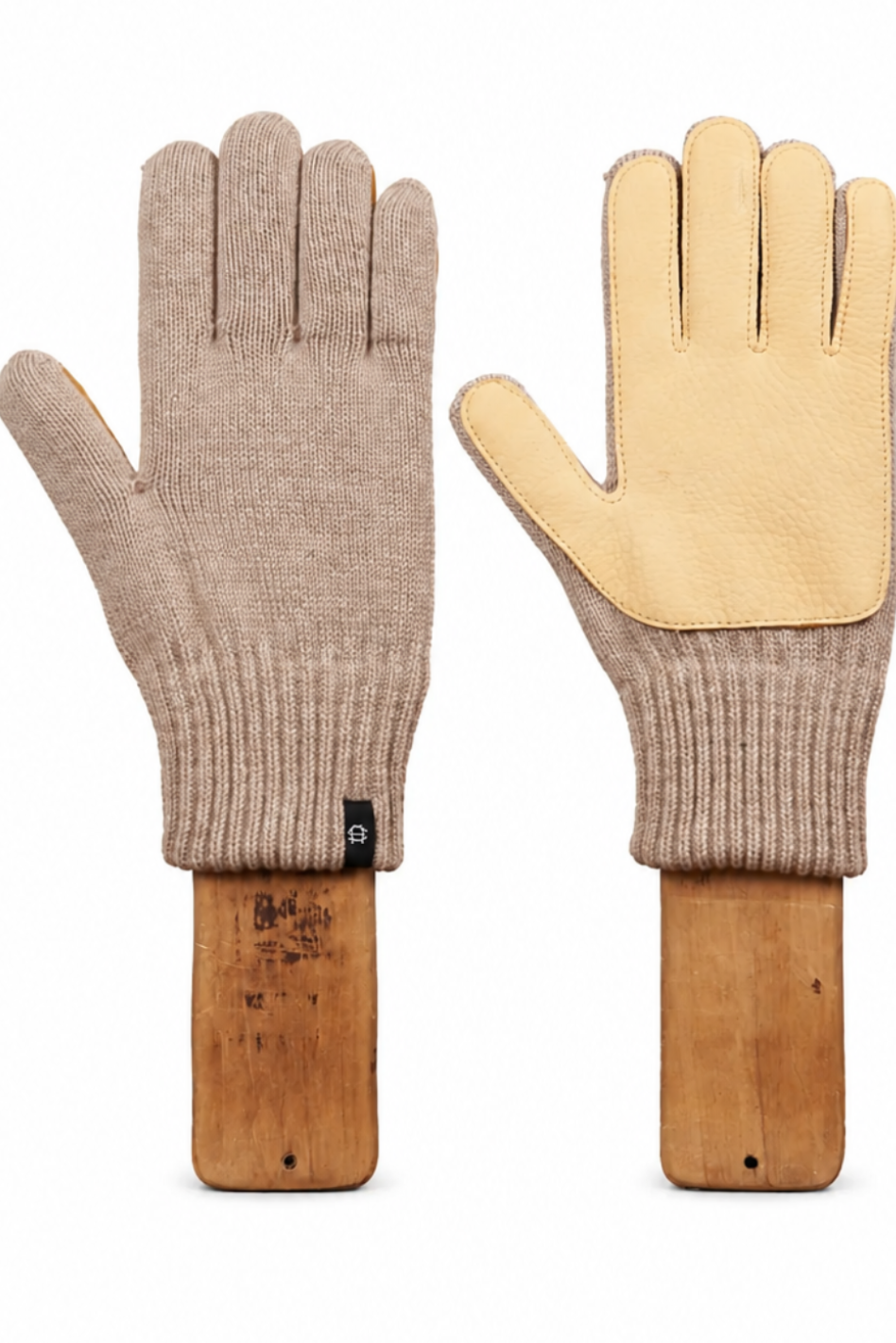 A pair of knit work gloves shown flat against a white background, mounted on wooden handles. One glove is beige with a tan leather palm, and the other is tan with a beige leather palm.