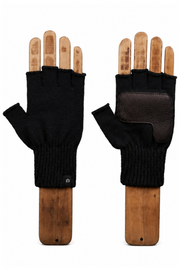 A pair of black fingerless knit gloves with brown leather palm patches, displayed on wooden hand forms against a white background.