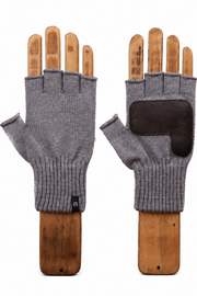 A pair of gray fingerless knit gloves displayed on wooden hand forms against a plain white background. One glove is shown palm-side with a ribbed cuff and a small black tag, and the other is shown back-side with a dark brown reinforced patch on the knuckle area.
