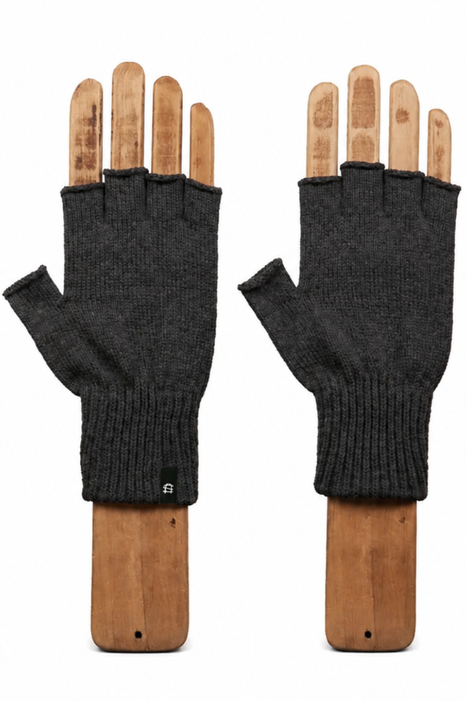 A pair of dark charcoal gray fingerless knit gloves displayed on wooden hand mannequins against a plain white background.