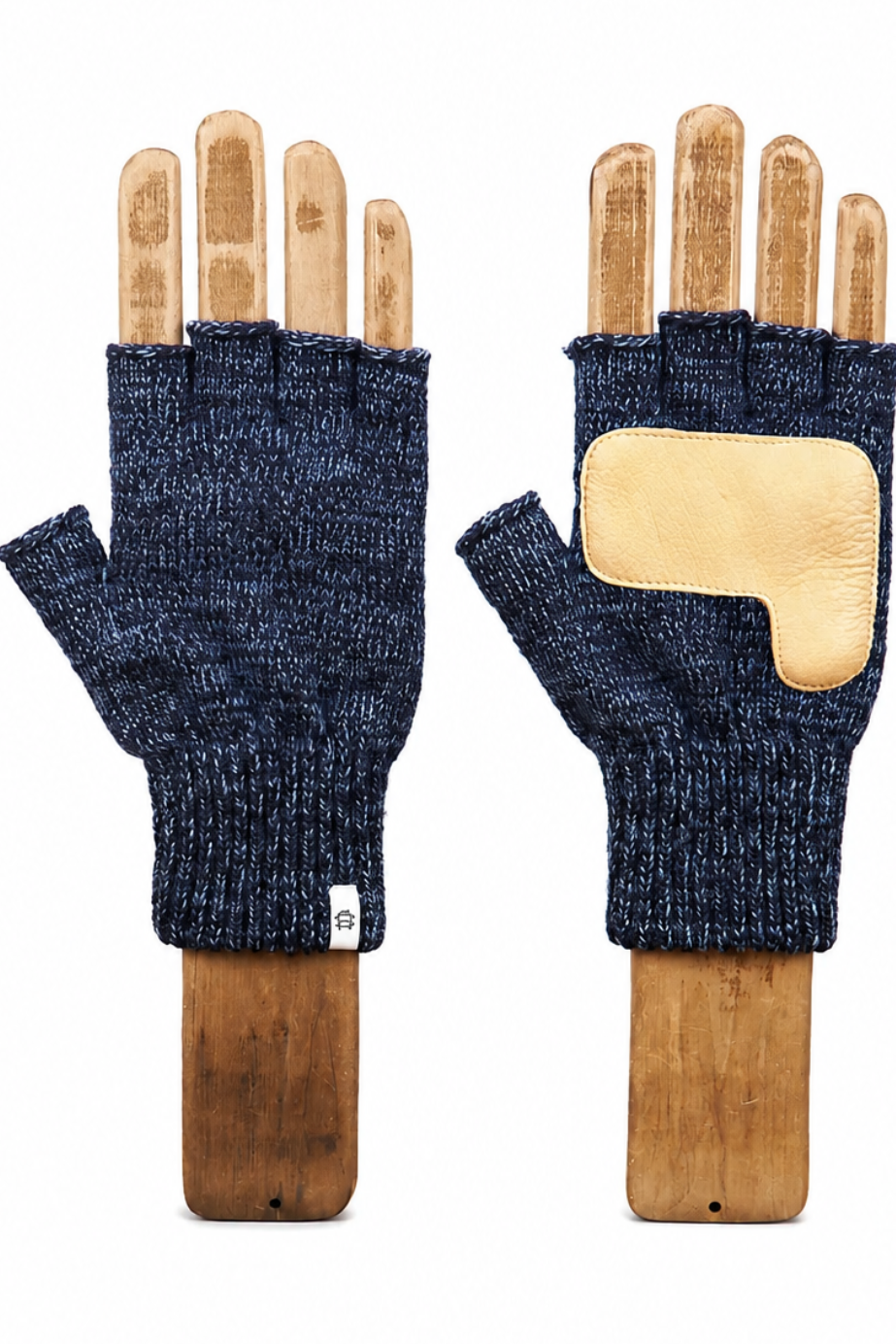 A pair of dark navy blue knit fingerless gloves displayed on wooden hand forms against a plain white background.