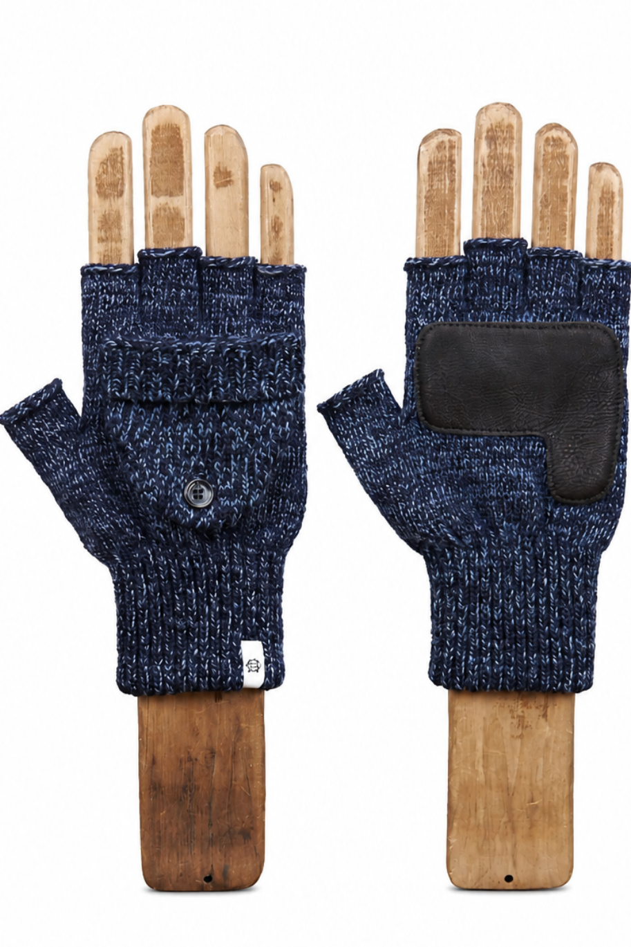 A pair of fingerless knit gloves displayed on wooden hand forms against a plain white background. One glove is shown palm-side with a dark blue marled knit body, a small metal button, and a white tag, while the other is shown back-side with a black rectangular patch on the back of the hand.