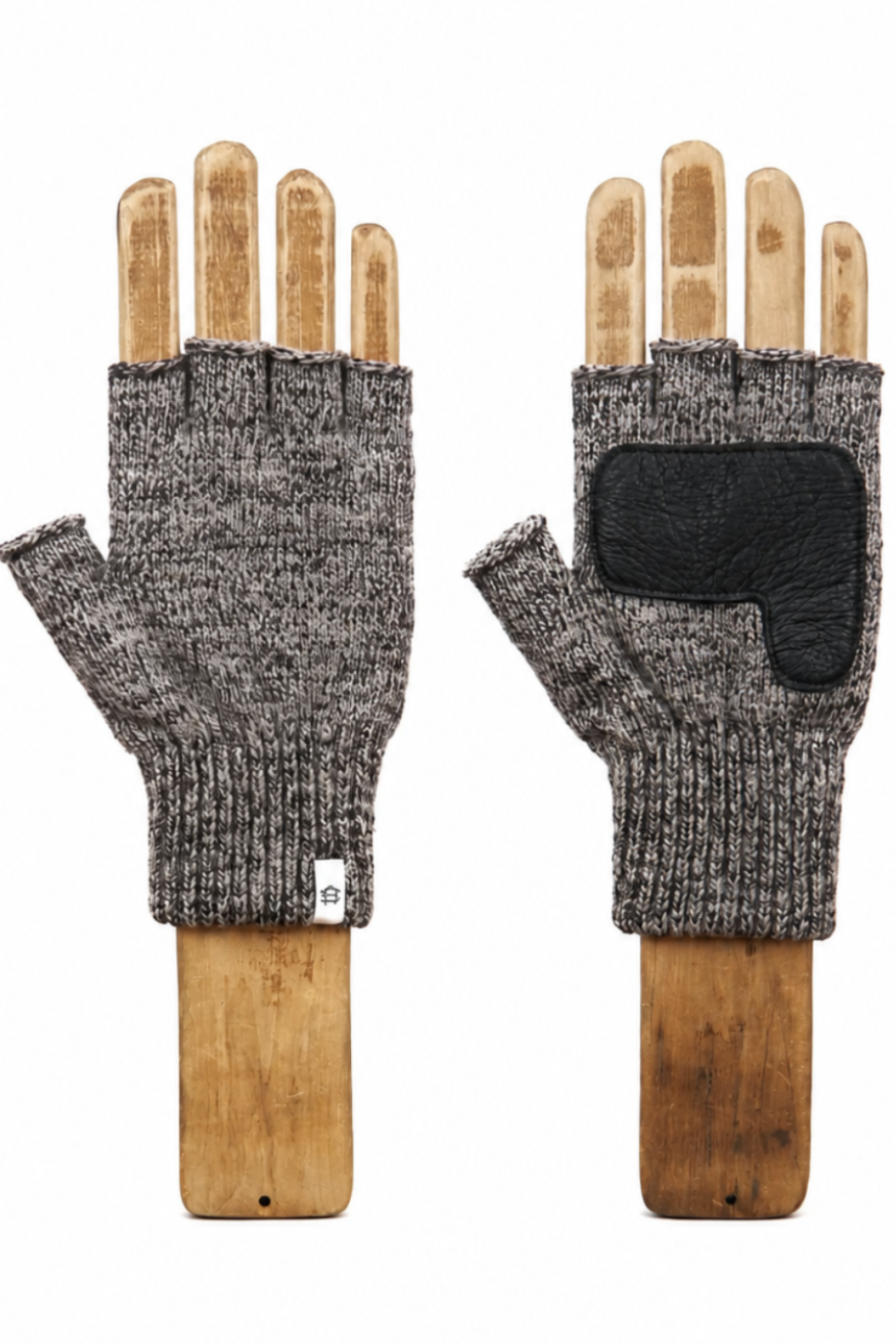 A pair of fingerless knit gloves in heather gray and black, displayed on wooden hand mannequins against a plain white background.