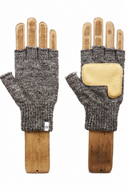 A pair of fingerless knit gloves displayed on wooden hand forms against a plain white background. The gloves are heather gray on the knit body with a contrasting light tan leather patch on the back of one glove.