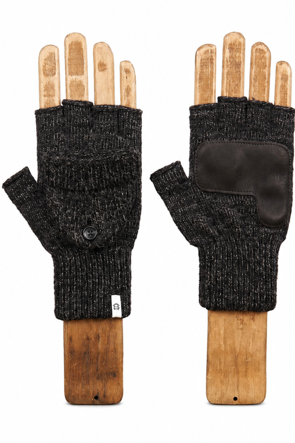 A pair of black fingerless knit gloves displayed on wooden hand forms against a plain white background.