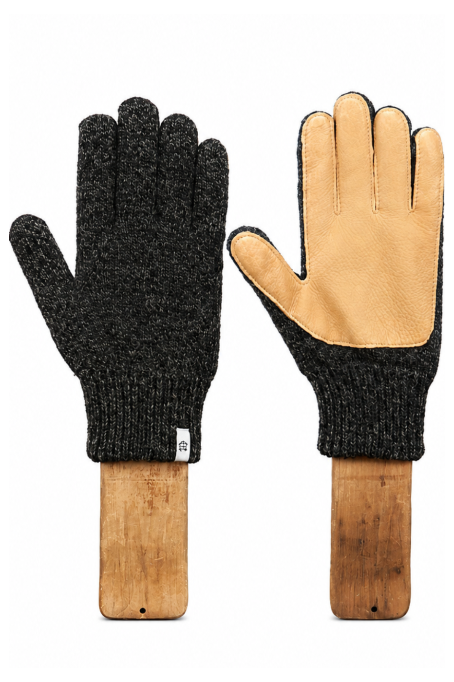 A pair of knit winter gloves displayed on wooden mannequin forms against a white background. One glove is shown palm-side with a dark charcoal heathered knit body and tan leather palms, and the other is shown back-side with the same dark knit and a tan leather cuff.