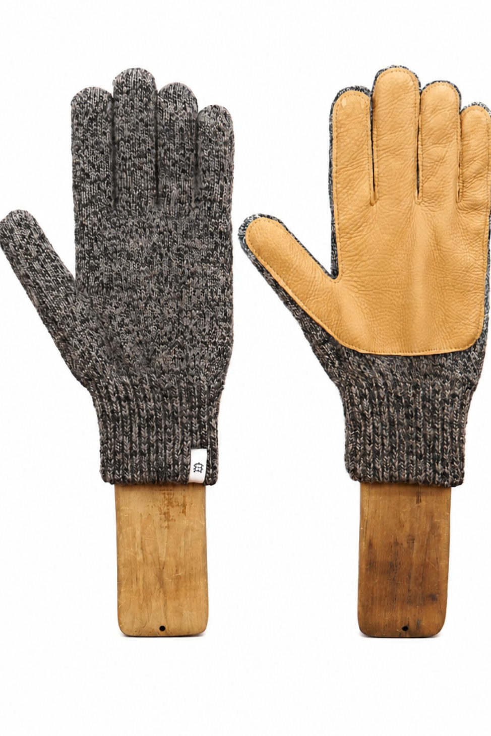 A pair of knit work gloves shown front and back on wooden mannequin hands. The left glove shows the dark gray heathered knit back, and the right glove shows the tan leather palm side.