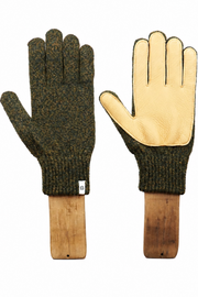 A pair of work gloves displayed side-by-side on wooden handles against a plain white background. One glove shows the dark olive green knit back, and the other shows the light tan leather palm side.