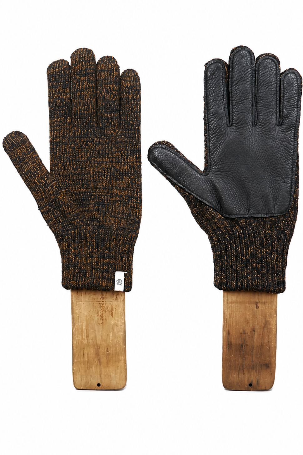 A pair of knit winter gloves with black leather palm and back-of-hand panels, displayed on wooden mannequin forms against a white background.