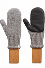A pair of knit winter mittens displayed side by side on wooden stands against a plain white background. One mitten is shown from the back, featuring a heather gray ribbed knit body and a black leather palm.