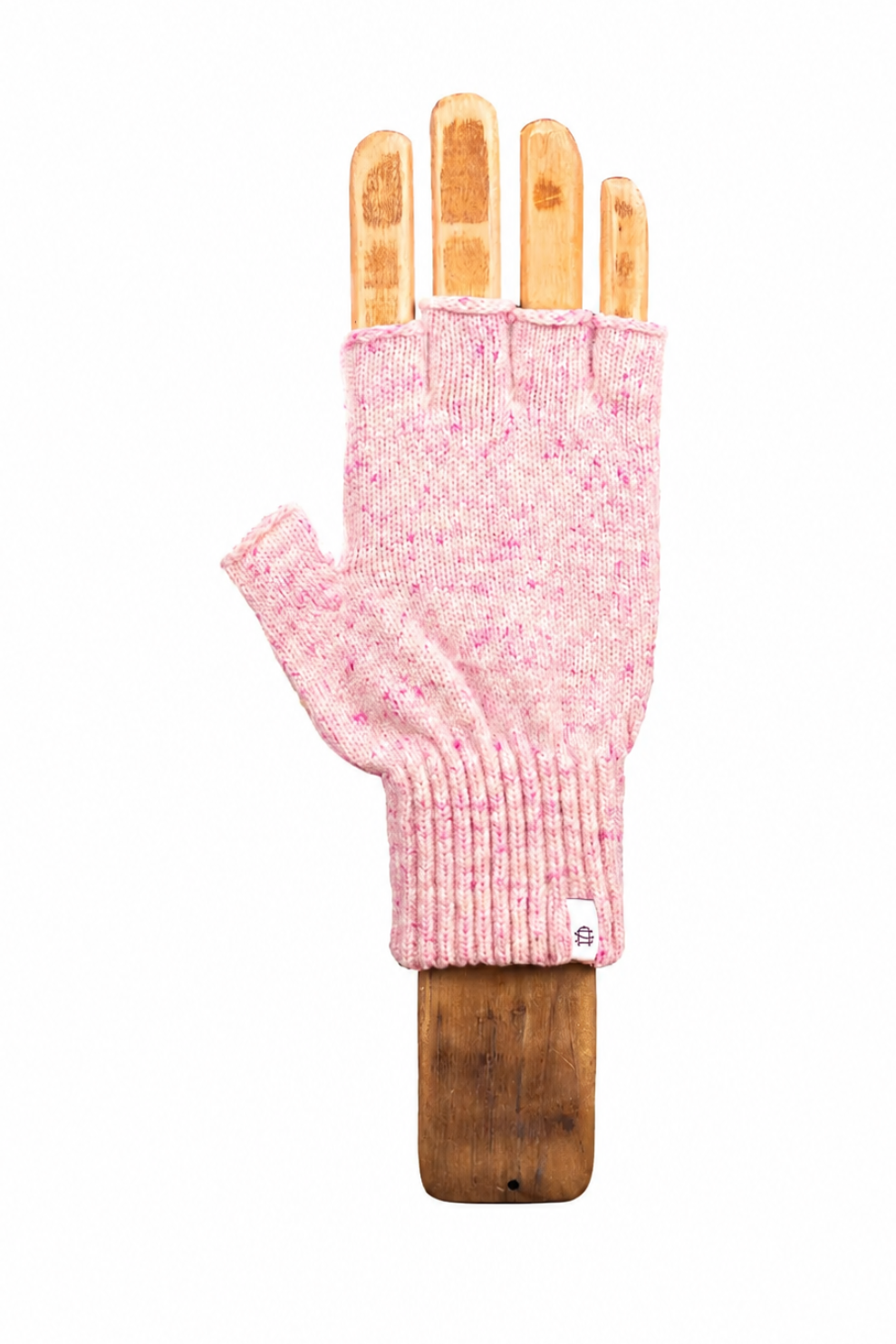 A light pink heathered knit fingerless glove displayed on a wooden hand form against a plain white background.
