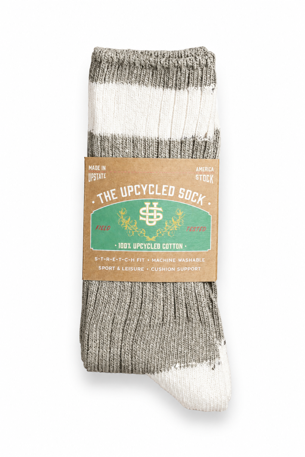 A single ribbed knit sock in heather gray and off-white, wrapped with a brown paper label that reads 'THE UPCYCLED SOCK' and '100% UPCYCLED COTTON'.