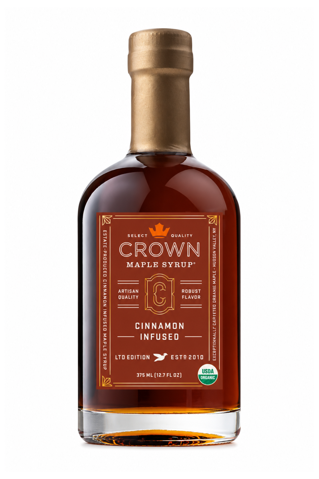 A bottle of Crown Maple Syrup, Cinnamon Infused, with amber liquid, a gold cap, and a brown label on a white background.
